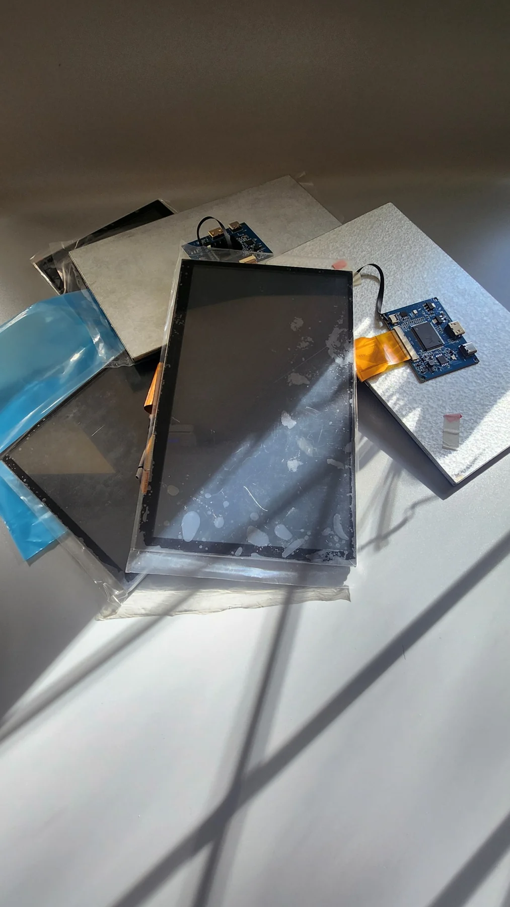 Collection of rejected LCD screens, display controllers and ribbon connections